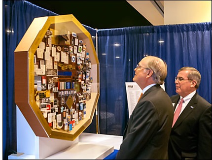 President and CEO Bill Githens shares the 100th anniversary artwork with an RMA member.