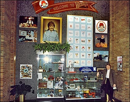 Kitty with the Wendy's wall of memorabilia in 1994