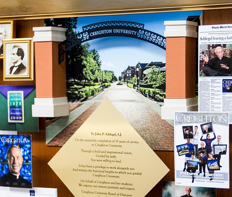 Large collage with over 65 items for the president of Creighton University. Close-up of the 3D replica of the Creighton University entrance and the dedication.