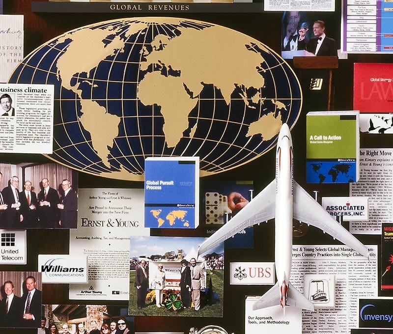 Large collage with over 50 items for Ernst and Young. This close-up shows a 3D metal globe and a mini plane.