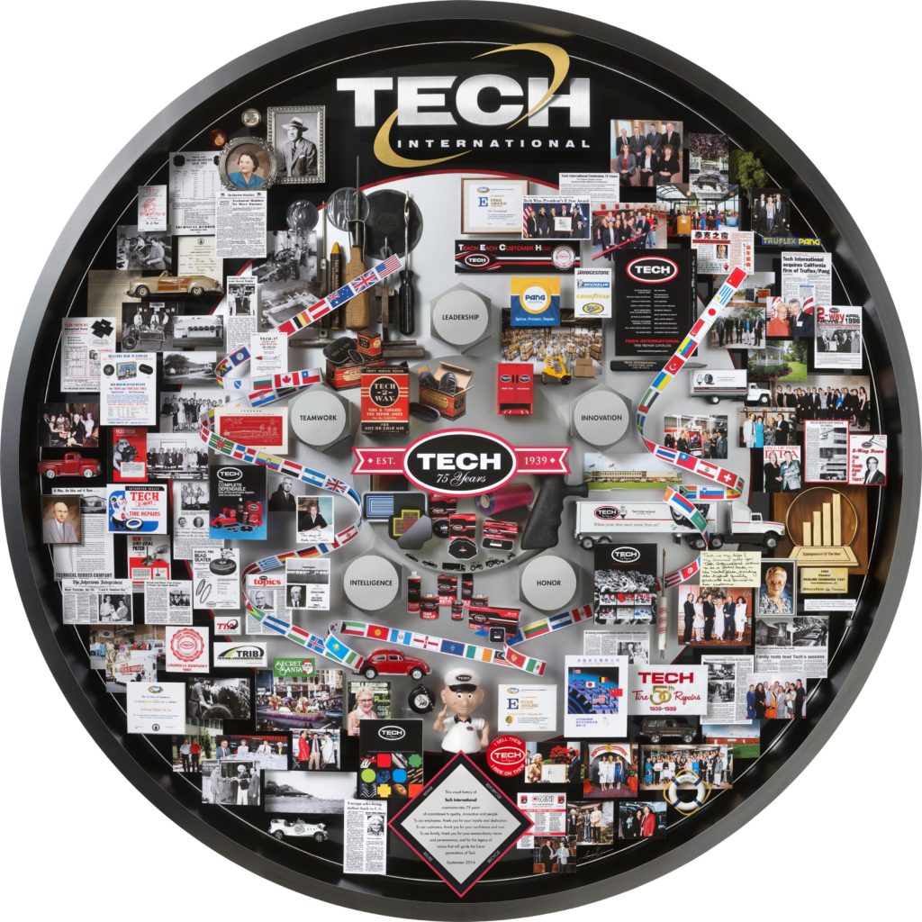 Tech International 75th anniversary lobby art. Reproduced as posters. Contains ribbon of flags, Tech bobblehead, awards, miniature cars, tools