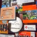 Large collage with over 50 items for the president and CEO of Exelis. Close-up of some of the miniaturized photos and publications.