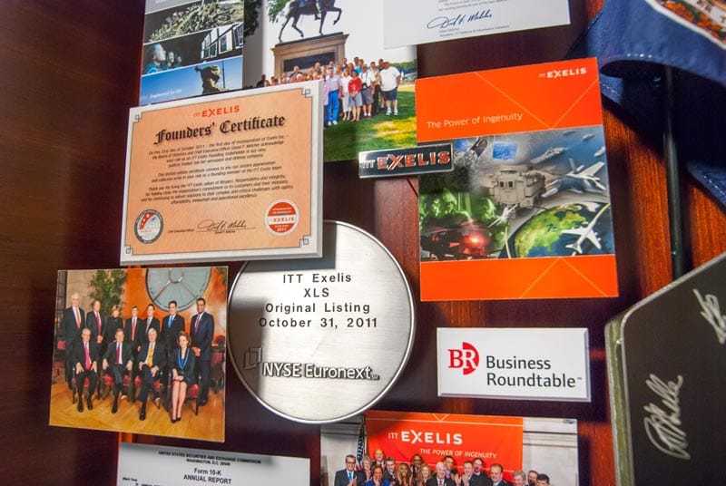 Large collage with over 50 items for the president and CEO of Exelis. Close-up of some of the miniaturized photos and publications.