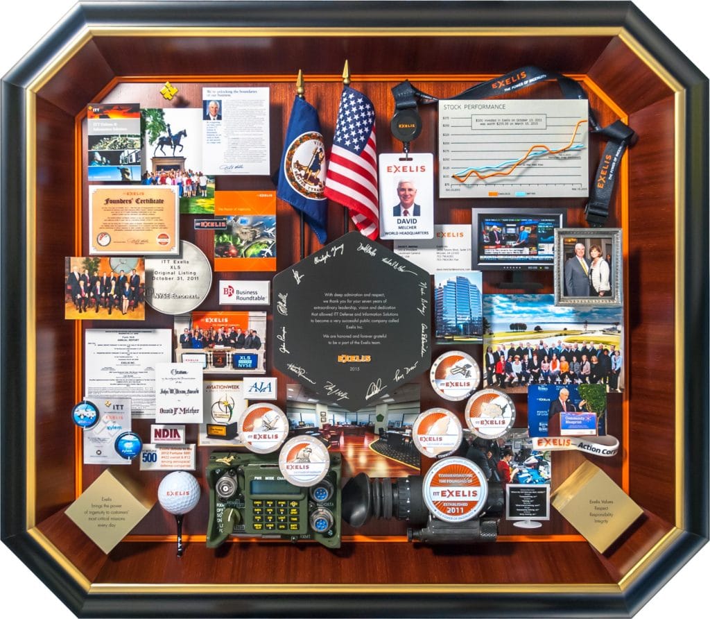 Large collage with over 50 items for the president and CEO of Exelis. Containing items and images that celebrate the company's history and honor the CEO's leadership and accomplishments.