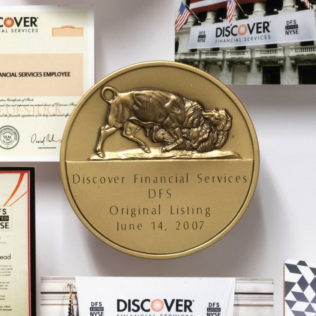 Large collage personalized with over 60 items for the CEO of Discover. Close-up showcases medallion of Discover DFS initial NYSE listing.