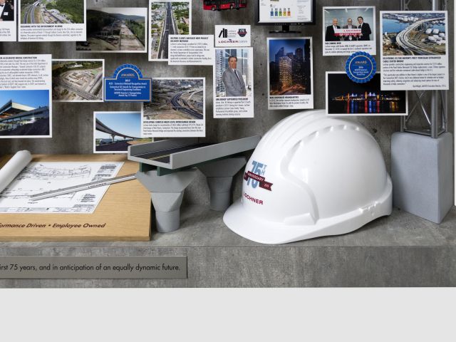 Close-up of 3D miniature objects in commemorative collage including large hard hat