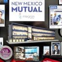 3-dimensional collage containing miniaturized items includes 3D replica of New Mexico Mutual headquarters building.