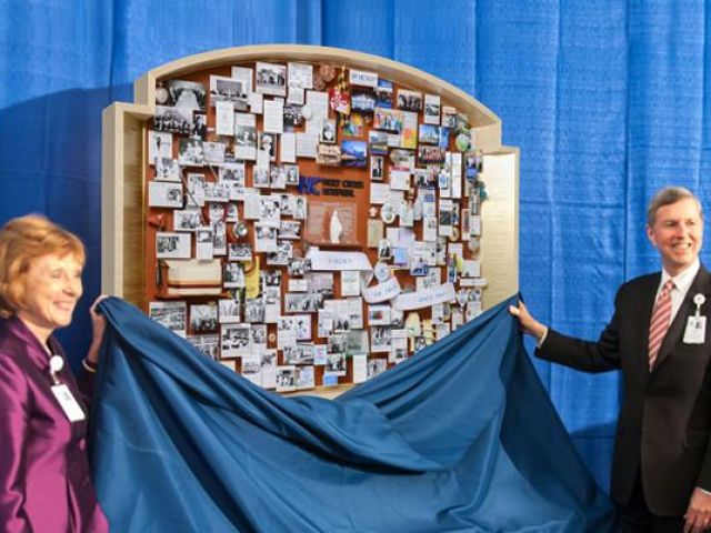 Anniversary collage for Johns Hopkins being unveiled with drape