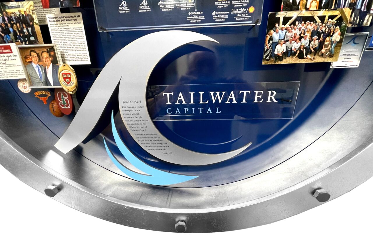 Close-up of 3D miniature objects in commemorative collage including silver metal ocean wave