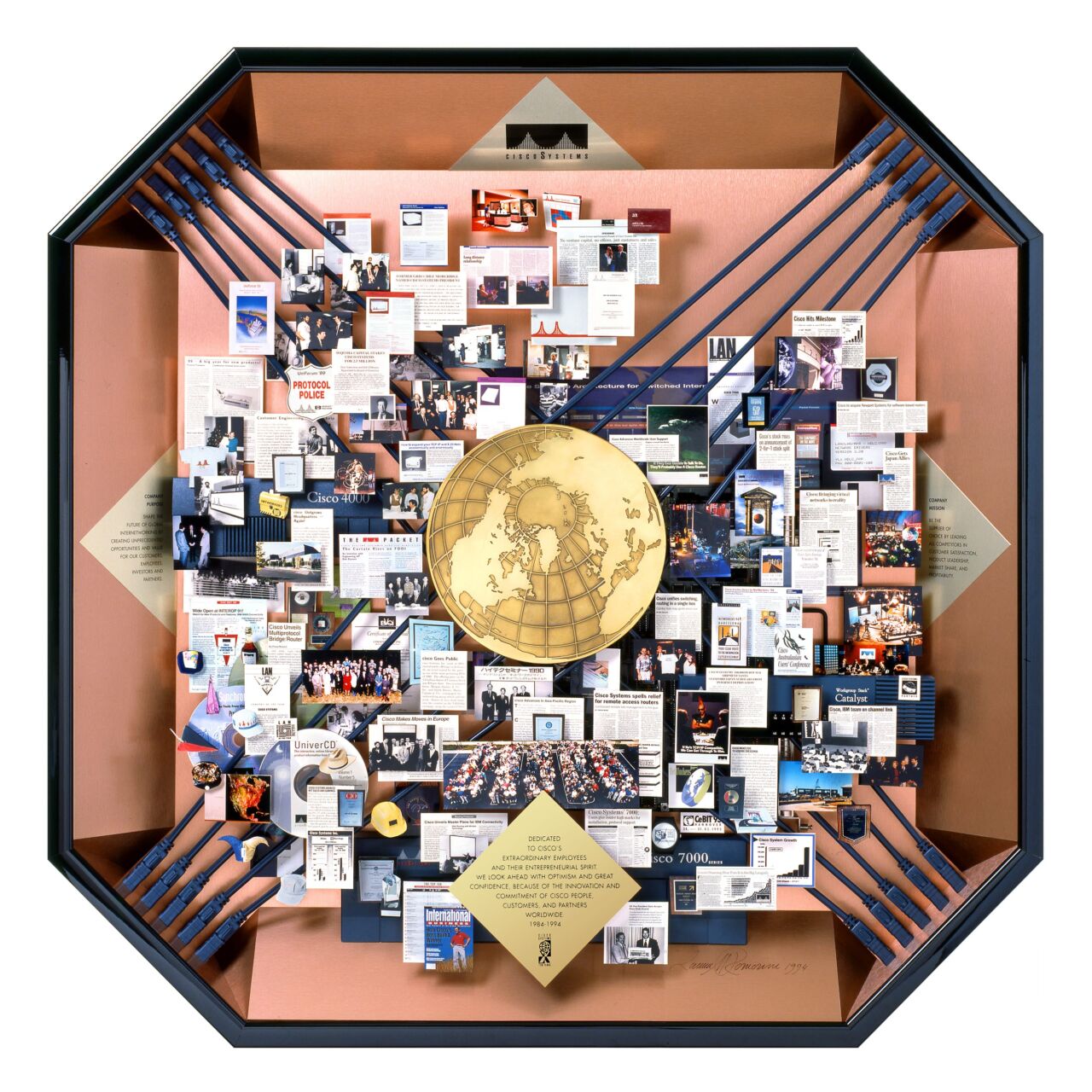 Shadow box collage commemorating Cisco System's 10th Anniversary including router cables and gold globe medallion
