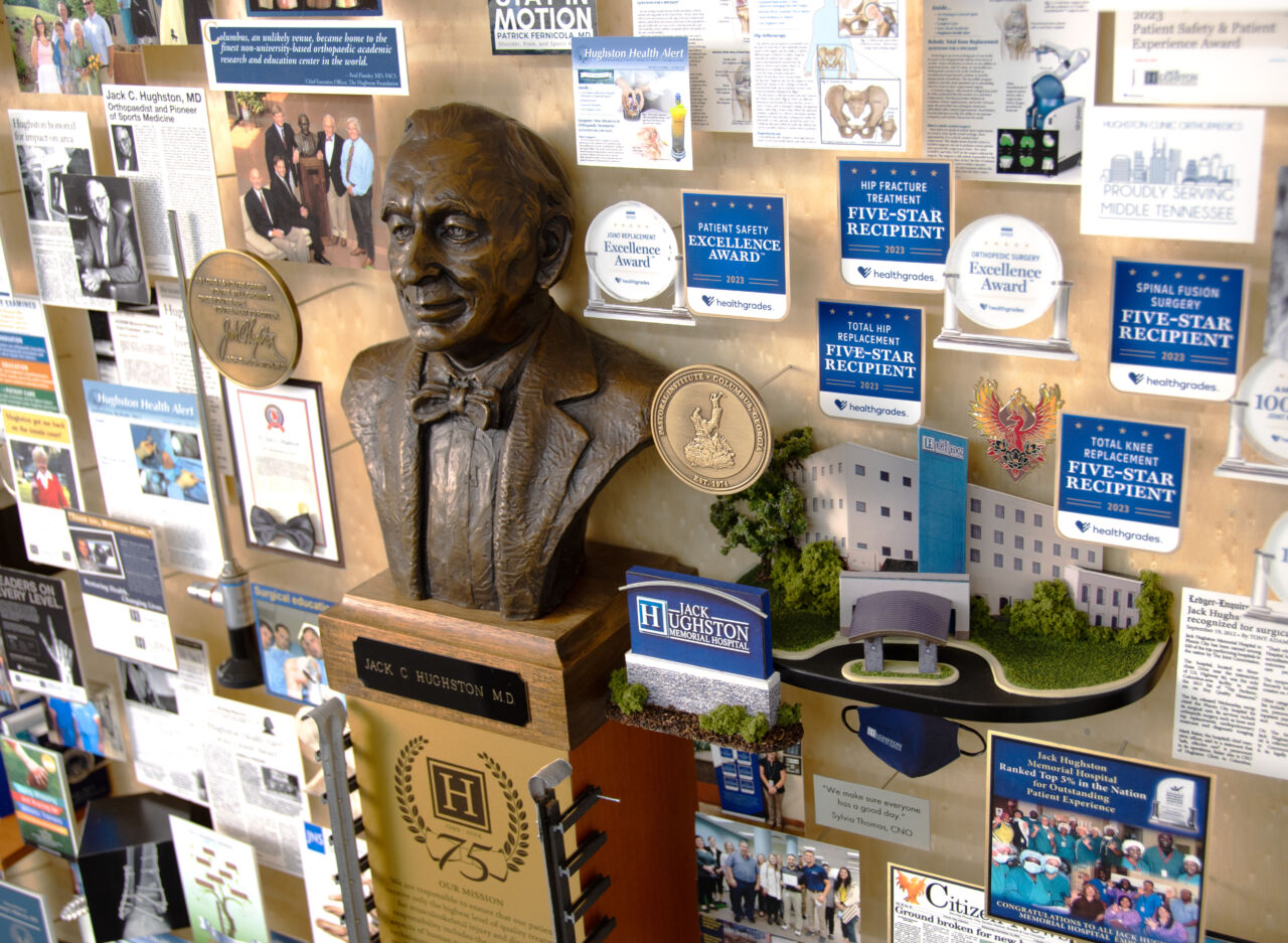 Close-up of 3D miniature objects in commemorative collage including bust of founder