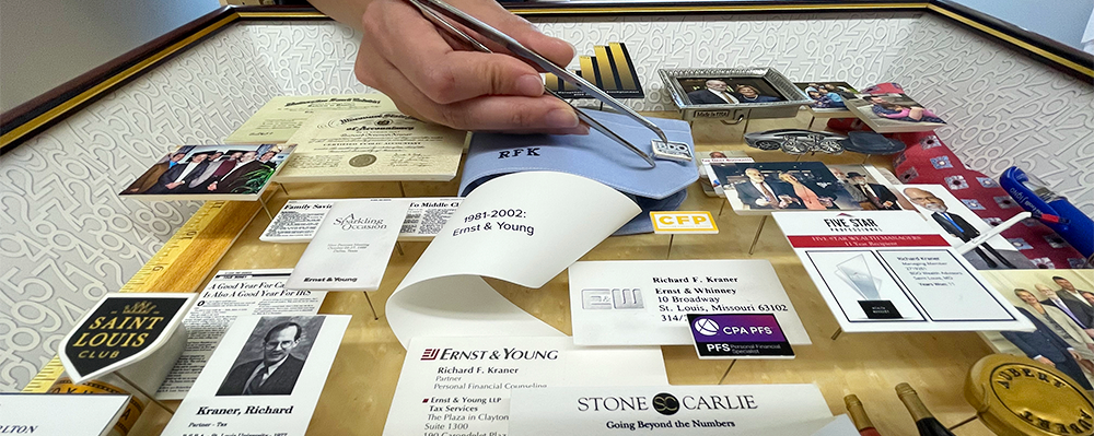 Artist hand placing cuff link in collage using tweezers