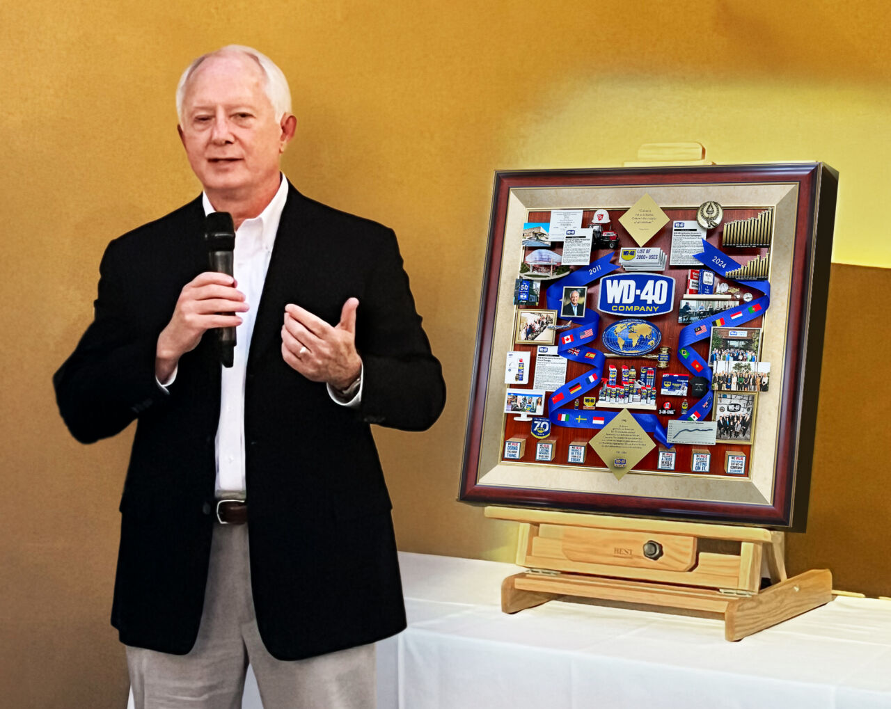 WD-40 Retiring Board Chairman standing next to artwork