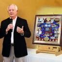 WD-40 Retiring Board Chairman standing next to artwork