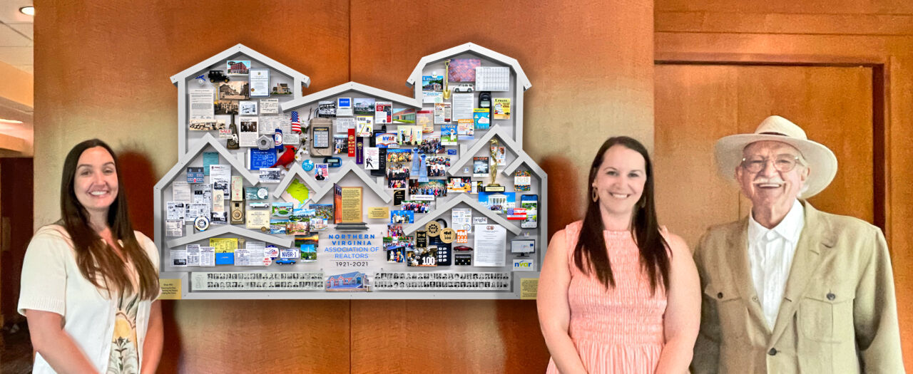 NVAR staff and the artist standing next to anniversary collage in lobby